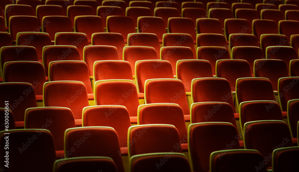 Naklejka premium Line of red theater chairs for background