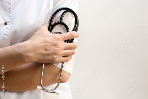Medical stethoscope the hands of a female doctor, close-up copy space.