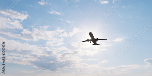 Airplane in the sky at sunset. Air transportation. Travel. Airplane Takes Off Against the Background of Blue Sky. 
