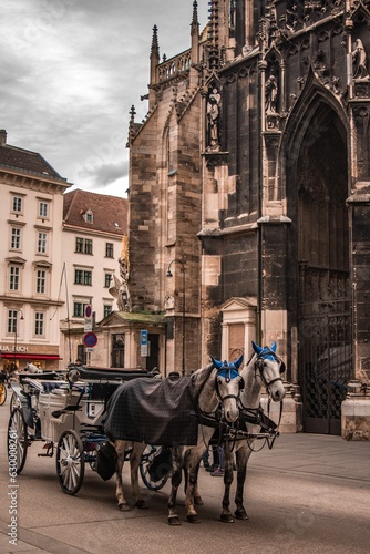 Canvas Print Majestic horses pulling a classic horse-drawn carriage in front of a grand build