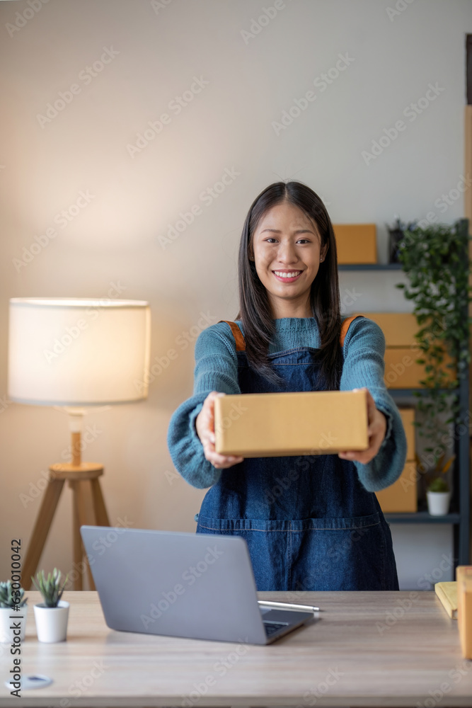 Online business concept, Asian business women holds parcel boxes of product for delivery to client. Online business concept, Asian business women holds parcel boxes of product for delivery to client.