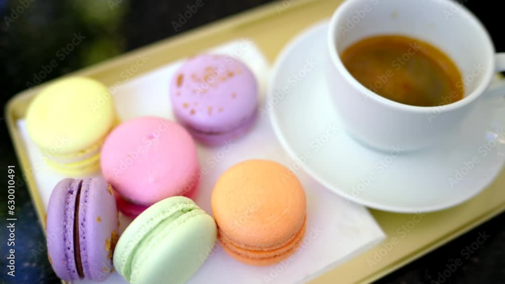 Colored french macarons with a cup of black cofee Colored french macarons with a cup of black cofee