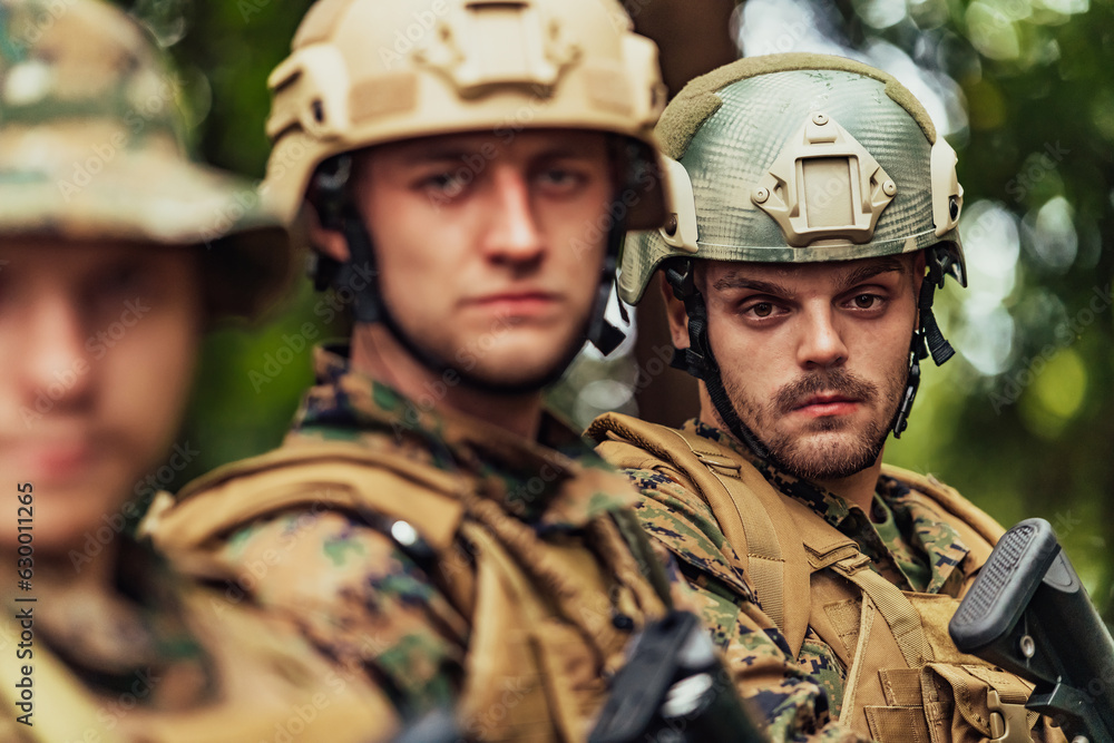 Soldier fighters standing together with guns. Group portrait of US army elite members, private military company servicemen, anti terrorist squad Soldier fighters standing together with guns. Group portrait of US army elite members, private military company servicemen, anti terrorist squad
