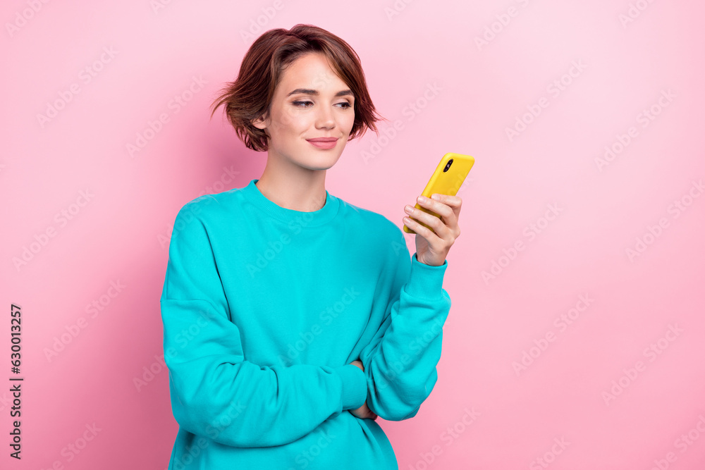 Photo portrait of attractive young woman hold device read news comment wear trendy blue clothes isolated on pink color background Photo portrait of attractive young woman hold device read news comment wear trendy blue clothes isolated on pink color background