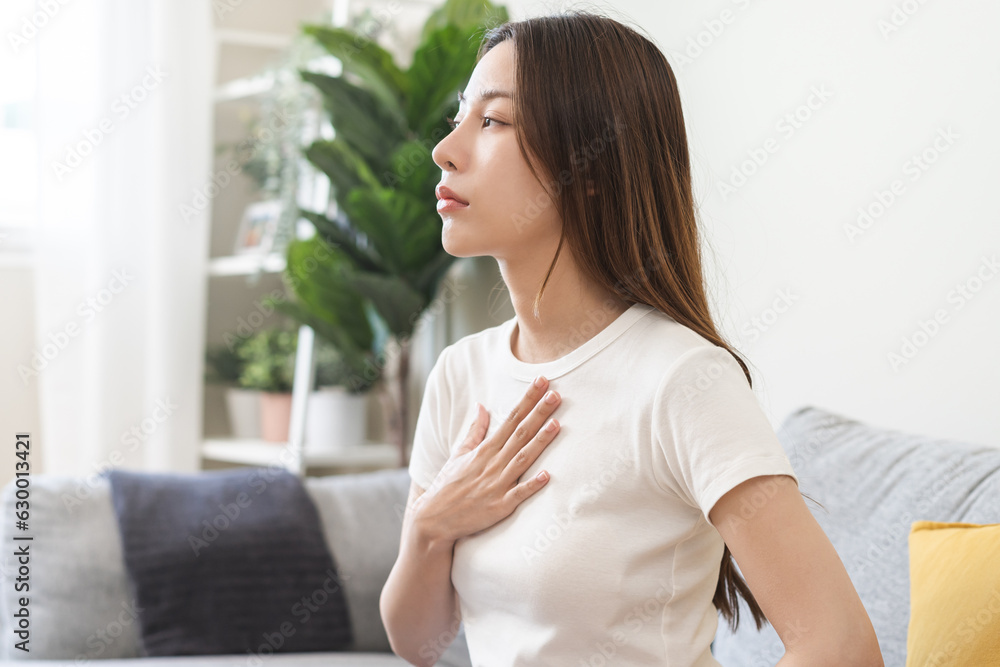 Acid reflux disease, suffer asian young woman have symptom gastroesophageal, esophageal, stomach ache and heartburn pain hand on chest from digestion problem after eat food, Healthcare medical concept Acid reflux disease, suffer asian young woman have symptom gastroesophageal, esophageal, stomach ache and heartburn pain hand on chest from digestion problem after eat food, Healthcare medical concept