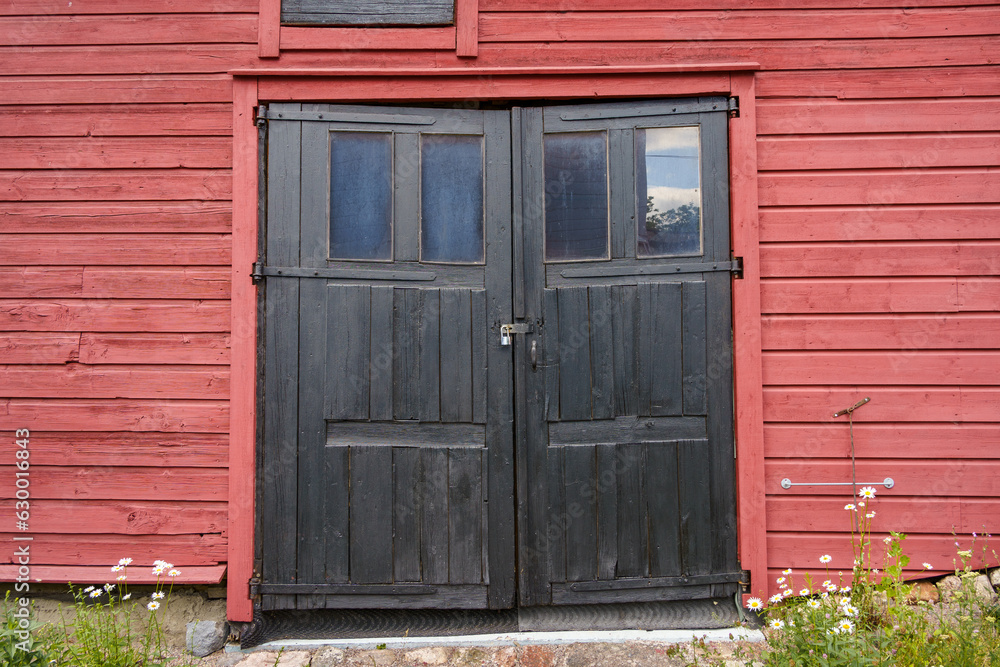 Old black wooden double doors in historical building in Finland. Old black wooden double doors in historical building in Finland.