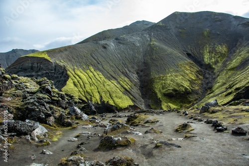 Fotografie Scenic landscape featuring a rocky valley and a mountain range