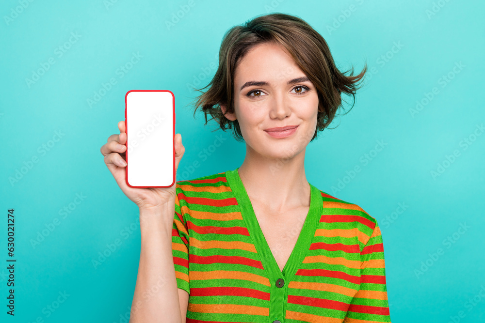 Portrait of pretty lady arm hold demonstrate empty space smart phone display isolated on teal color background Portrait of pretty lady arm hold demonstrate empty space smart phone display isolated on teal color background