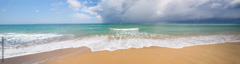 Beach on tropical island. Clear blue water, sand, clouds. Breathtaking view of ocean. Amazing vacation spot. Beautiful wallpaper for desktop, wallpaper. Concept of nature, travelling