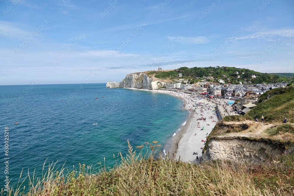 Picturesque beach situated near the coast on a bright day with many people