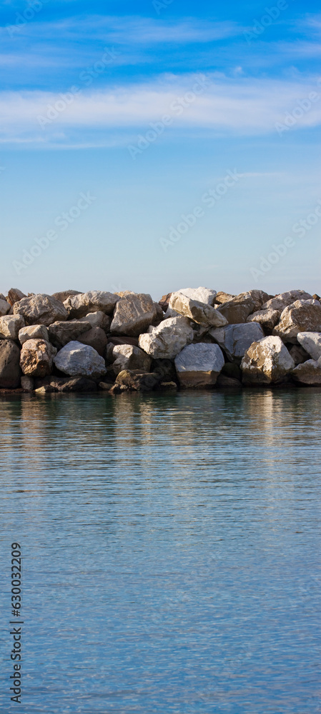 Dam with stone blocks for protection from sea storms - image with copy space Dam with stone blocks for protection from sea storms - image with copy space