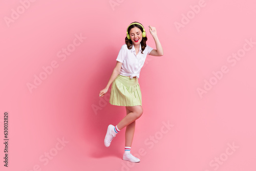 Full length photo of dreamy sweet woman dressed white shirt headphones dancing having fun isolated pink color background