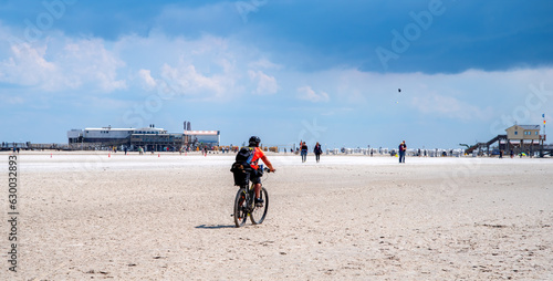 Cyclist on the beach of Sankt Peter Ording, North Sea, Germany photo