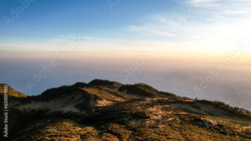 The beautiful Landscape view from Lawu Mountain at sunrise located in Magetan. One of the most beautiful mountains in Java with an altitude of 3265m above sea level.  © syahrir