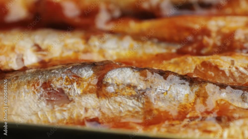 Opening canned sardine fish can, man open the canned seafood on the table. Close up on professional kitchen. Opening canned sardine fish can, man open the canned seafood on the table. Close up on professional kitchen.