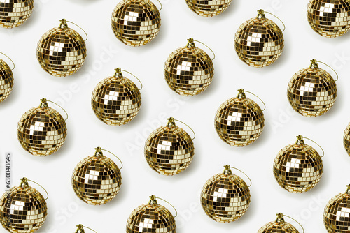Creative pattern with golden mirror balls on whitebackground, bright sparkling disco ball as Christmas toy, New Year party concept. Background for Christmas, xmas, winter holiday