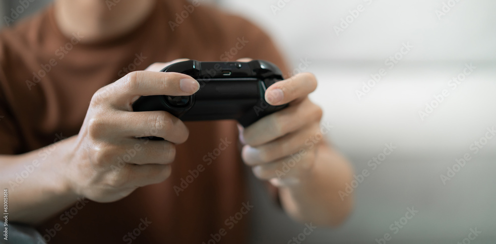 Young Asian man gamer wearing virtual reality touching air during the VR experience Future home technology player hobby playful enjoyment concept. Young Asian man gamer wearing virtual reality touching air during the VR experience Future home technology player hobby playful enjoyment concept.