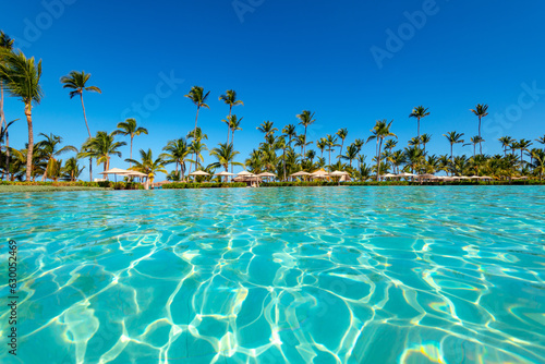 Fototapeta Naklejka Na Ścianę i Meble -  Swimming pool and palm trees in luxury resort at Punta Cana in the Dominican Republic