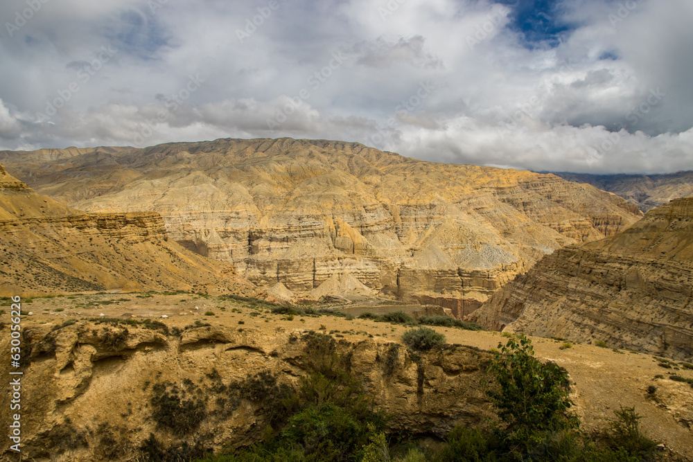 Breathtaking Cloudy Desert Landscape of Upper Mustang captured from Chele Village in Himalaya Nepal