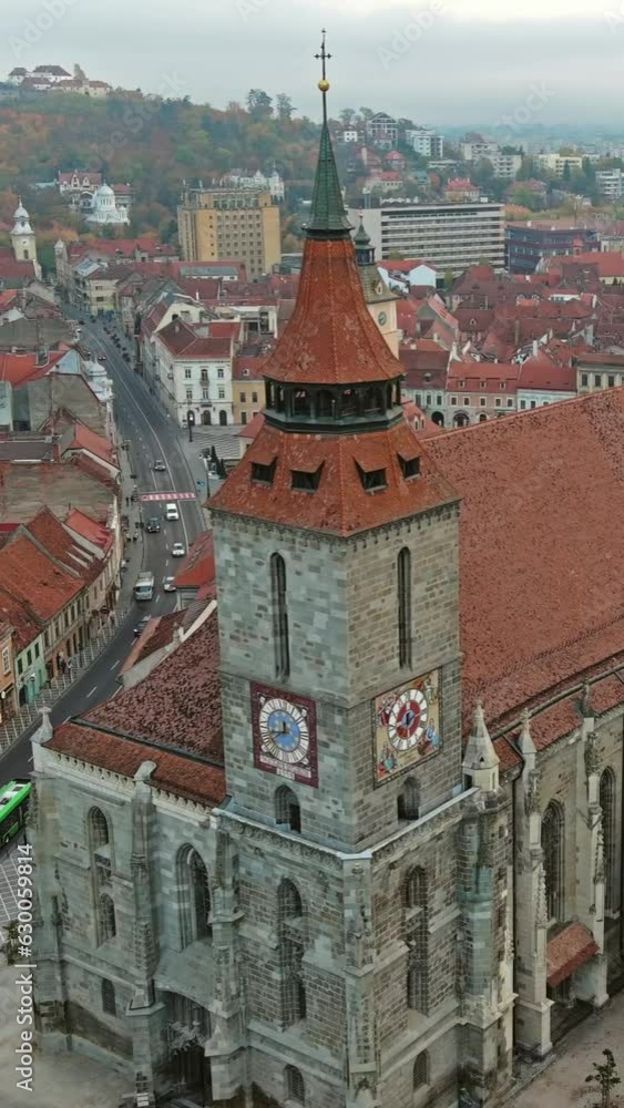Aerial around view of Brasov old town with Black Church in autumn, Transylvania region, Romania. Vertical video Aerial around view of Brasov old town with Black Church in autumn, Transylvania region, Romania. Vertical video