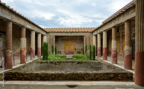 View of outdoor patio lined with columns in the historic city of Pompei, Italy, which was destroyed by Vesuvius volcano eruption in the year 79 AD © Lux Blue
