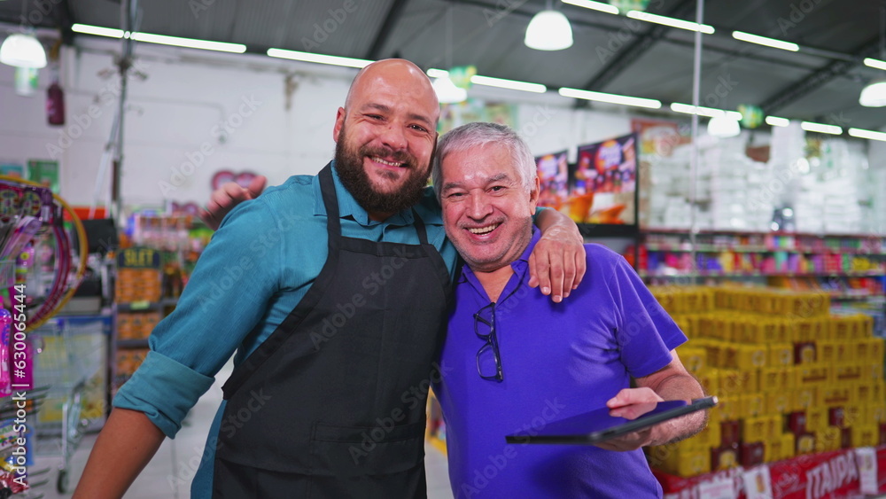 Two employees of Grocery store posing for camera, Brazilian workforce of supermarket, senior manager with staff Two employees of Grocery store posing for camera, Brazilian workforce of supermarket, senior manager with staff