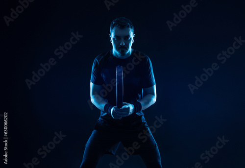 Fototapeta Naklejka Na Ścianę i Meble -  Padel tennis player. Man athlete with paddle tenis racket on black background. Sport concept. Download a high quality photo for sports website.