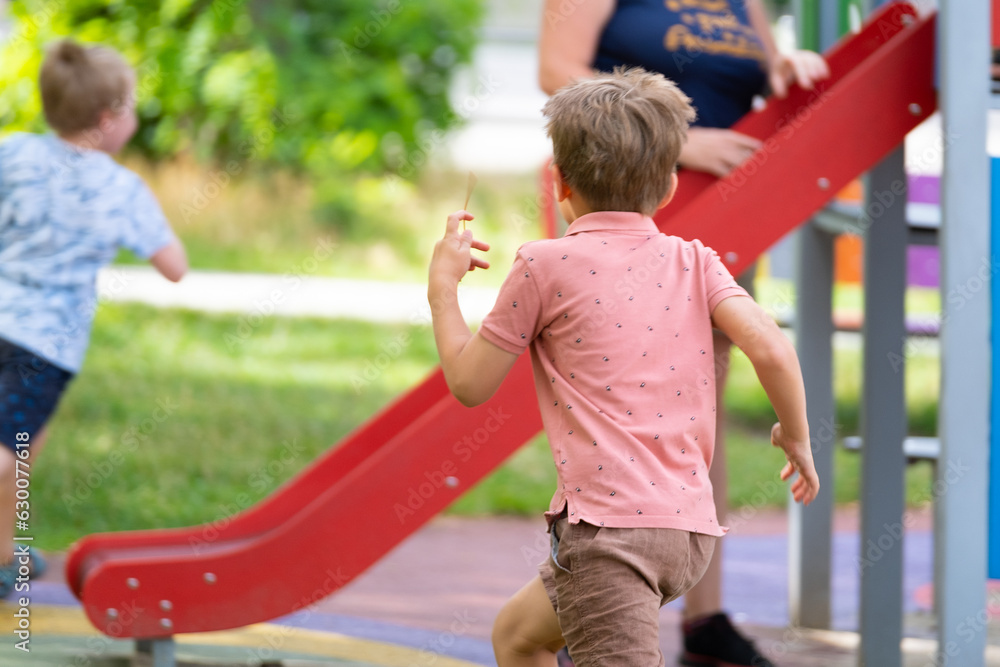 Obraz premium Portrait of six year old boy on playground in summer..