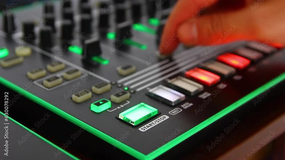 DJ's hands play on the remote, moving the sliders DJ's hands play on the remote, moving the sliders