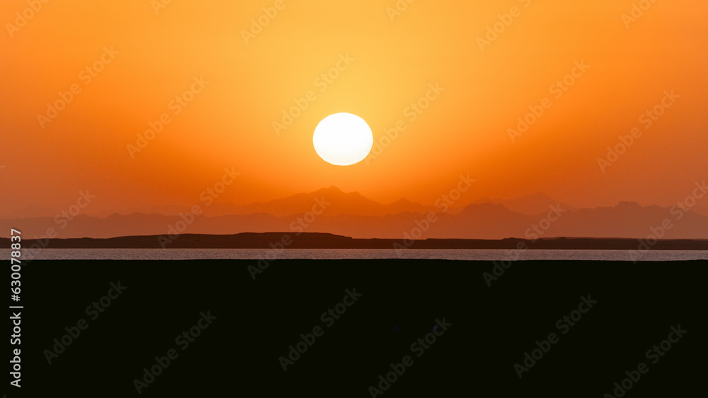 Epic sunset landscape sky with big bright sun going behind the mountains in Egypt. Epic sunset landscape sky with big bright sun going behind the mountains in Egypt.