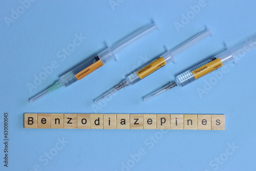 Benzodiazepines in tree syringe in a light blue background. Midazolam, lorazepam and diazepam photo