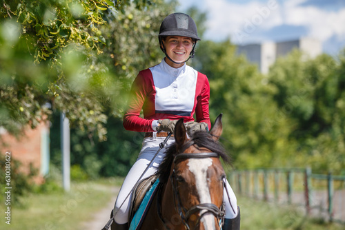 Photos Young smiling woman riding horse at ranch in the summer