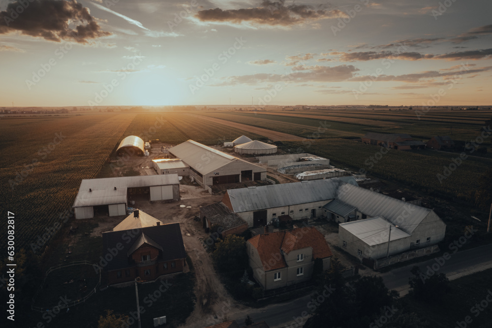 A view from above to the Polish farm against the background of the setting sun