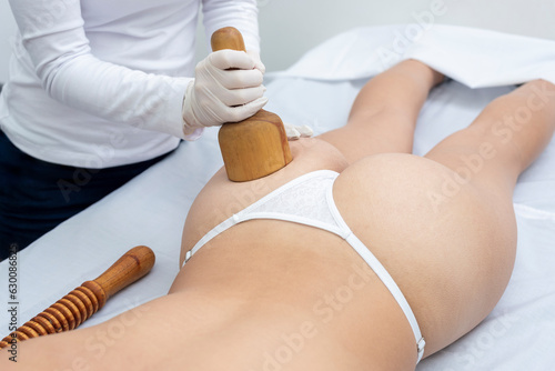 Body treatment in an aesthetic center with the technique of wood therapy for beauty, health and body care photo