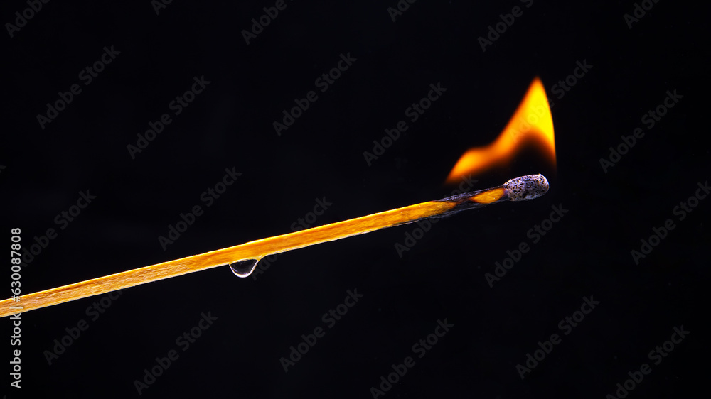 Burning wood match on a dark background close-up. burning tree fire Burning wood match on a dark background close-up. burning tree fire