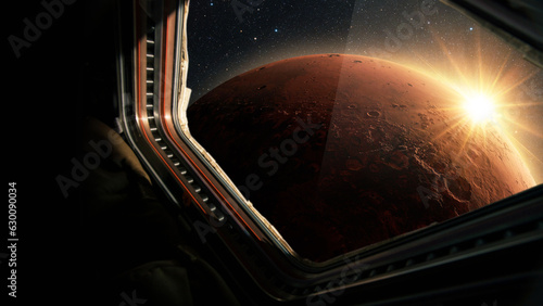 Fototapeta Naklejka Na Ścianę i Meble -  Spaceship flies near the amazing red planet Mars, view from the window. Travel and tourists in space, concept. Beautiful space view of the Mars with sunset. Hotel in space
