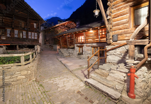 The rural architecture of Alagna village in the Valsesia valley range at dusk - Italy. photo
