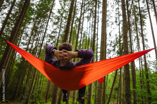 happy man in hammock in the middle of the forest