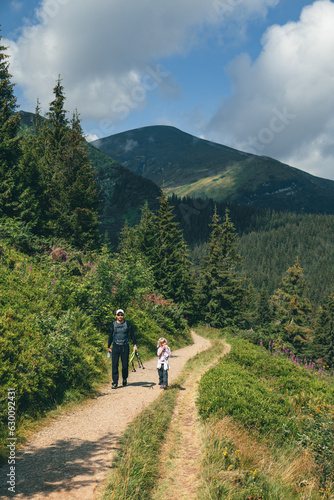 father with daughter at mountain trail