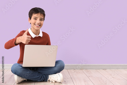 Little boy with laptop show...