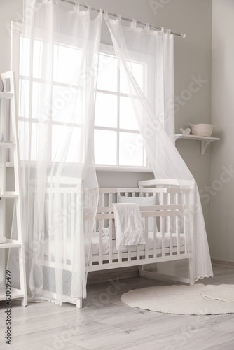 Fototapeta Naklejka Na Ścianę i Meble -  Interior of stylish children's bedroom with crib