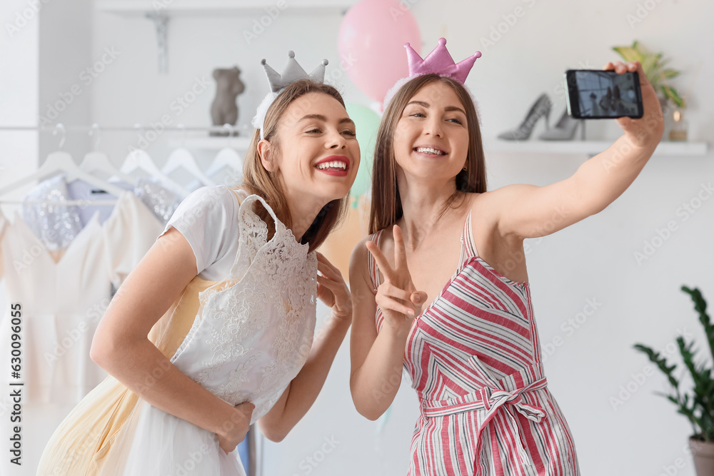 Female wedding planner with client taking selfie in office Female wedding planner with client taking selfie in office
