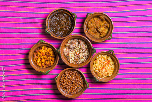 overhead view of traditional mexican dishes in handmade clay pots