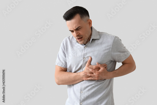 Young man having heart atta...
