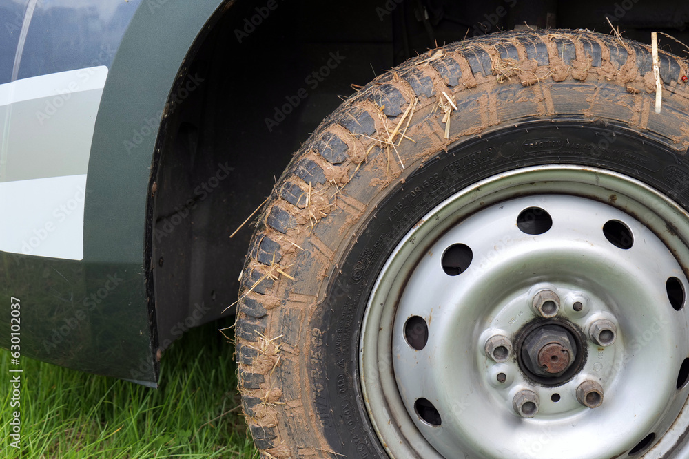 Motorhome wheel caked in mud, after spinning on a wet field. Motorhome wheel caked in mud, after spinning on a wet field.