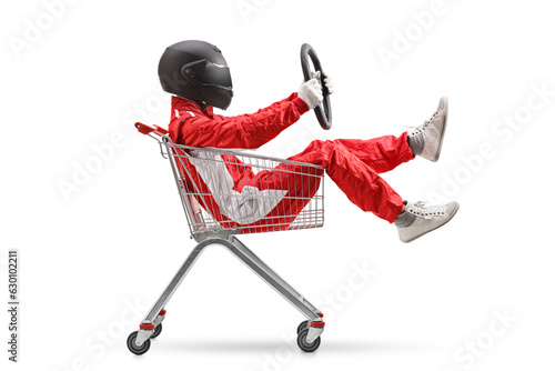 Racer holding a steering wheel and sitting inside a shopping cart © Ljupco Smokovski