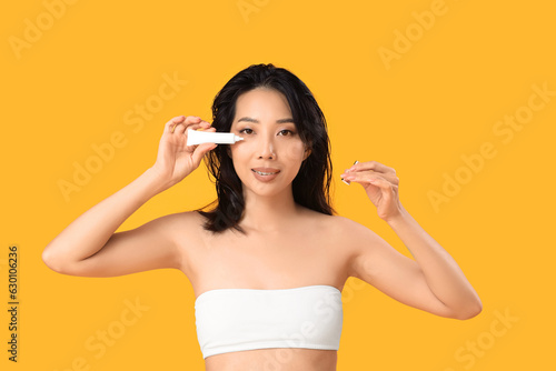 Young asian woman applying ...