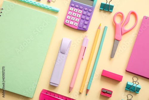 Different school stationery and notebooks on beige background