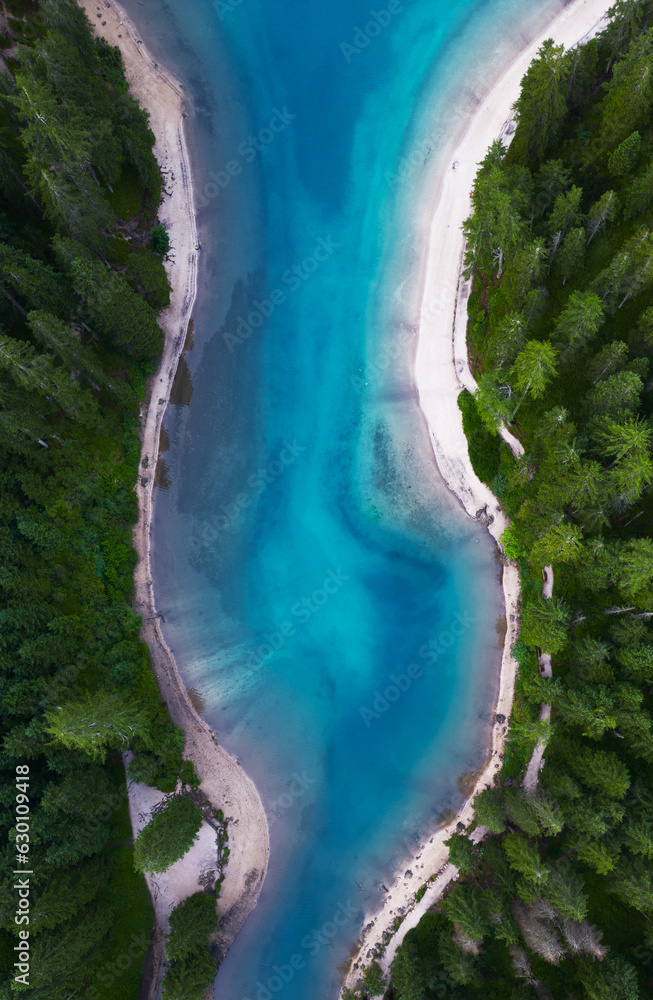 Lake Braies aerial view (also known as Pragser Wildsee or Lago di Braies) in Dolomites, Sudtirol, Italy. Romantic place with boat trailers on an alpine lake. Hiking and adventures.
