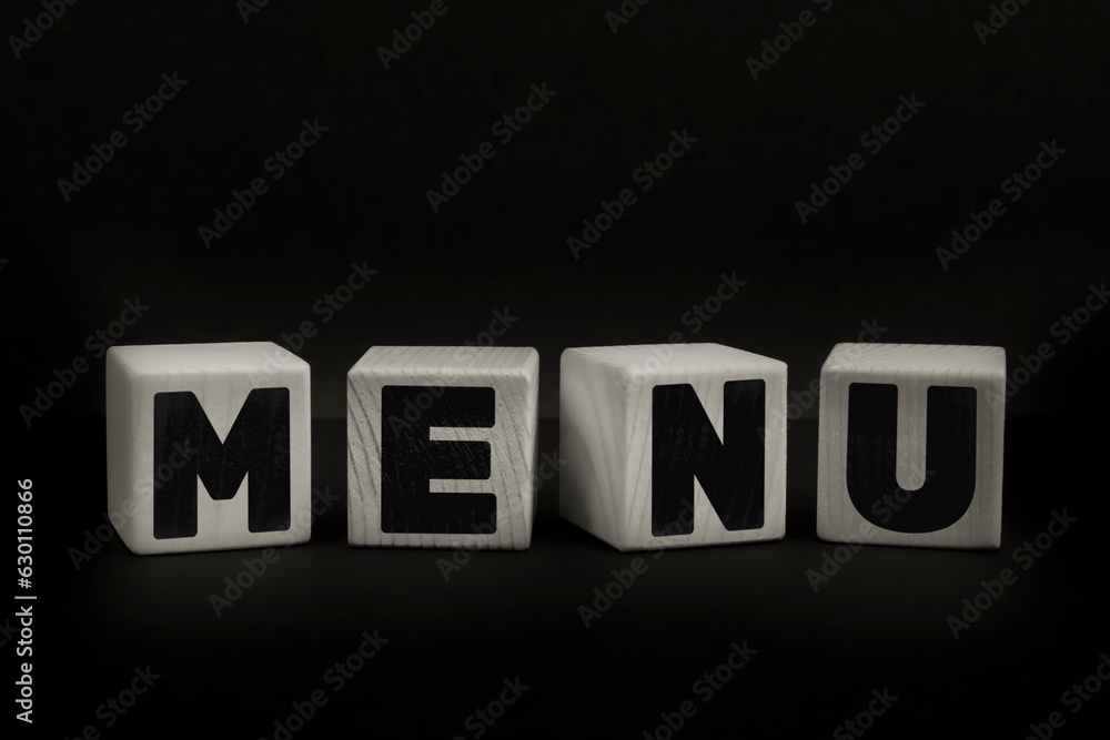 Obraz premium Word MENU written with wooden cubes. Studio shot of some arranged wooden blocks with a textual message.